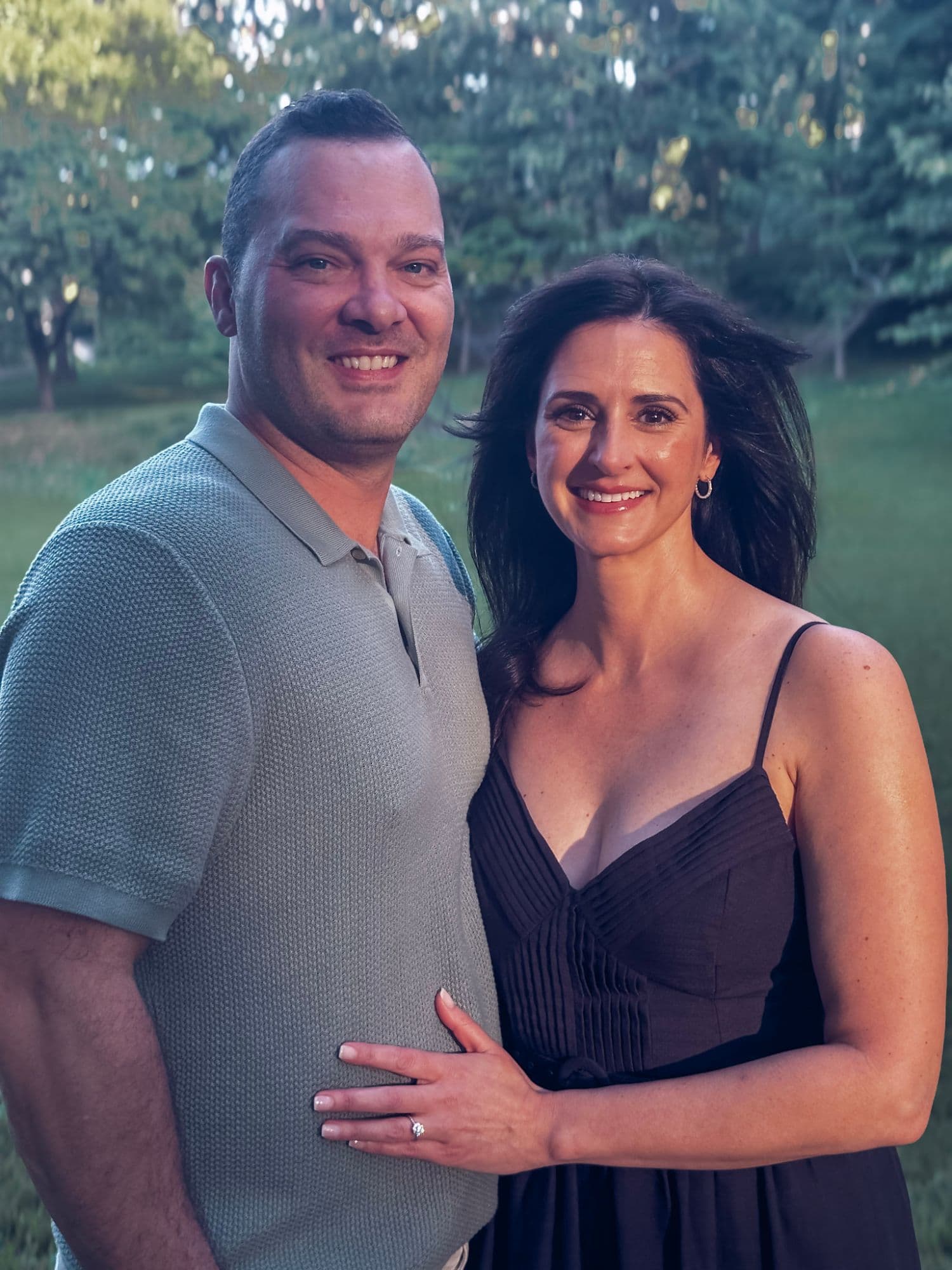 Laura and Nicholas at golden hour, engagement ring on display