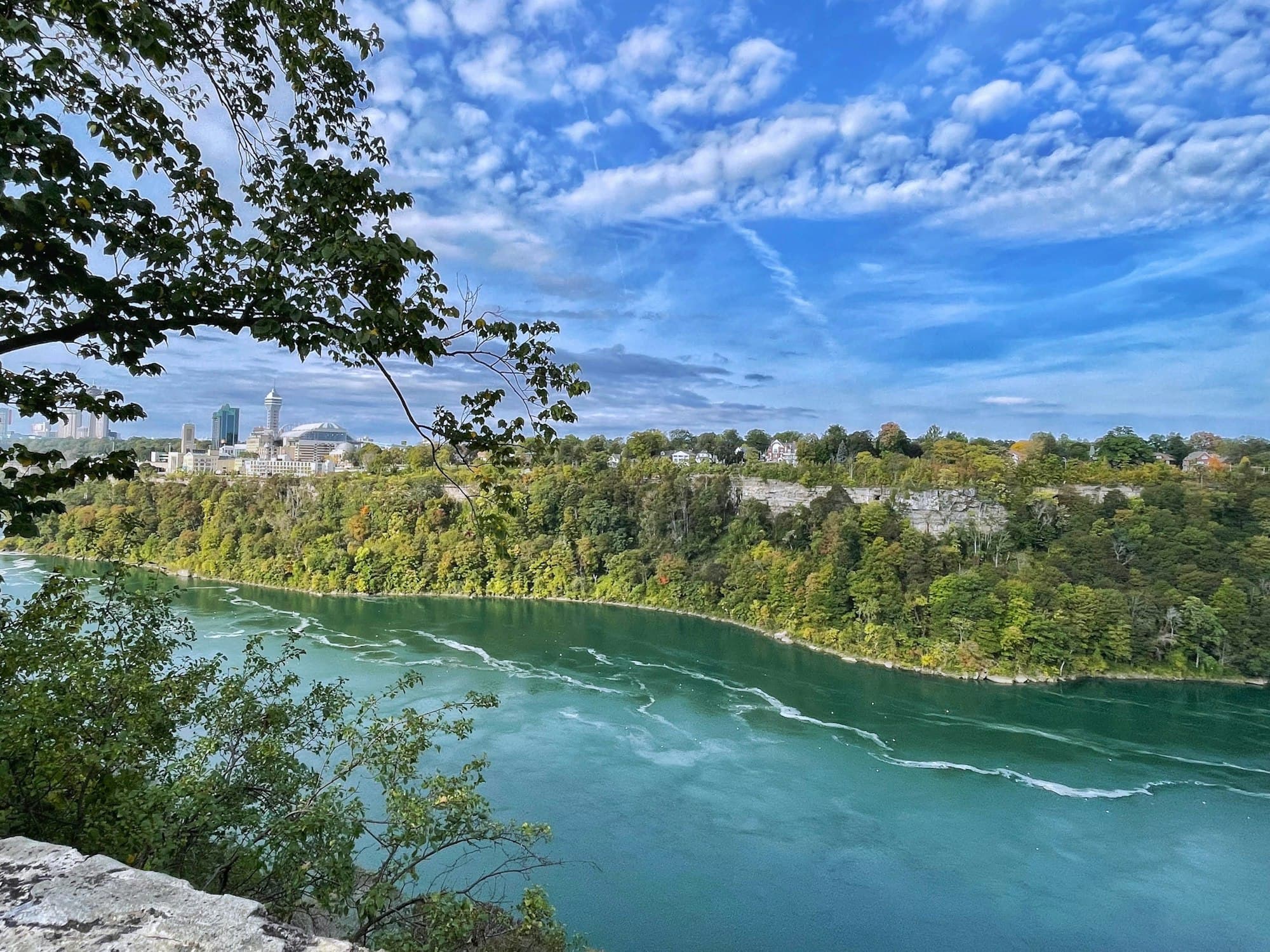 The turquoise Niagara River winding through its wooded gorge