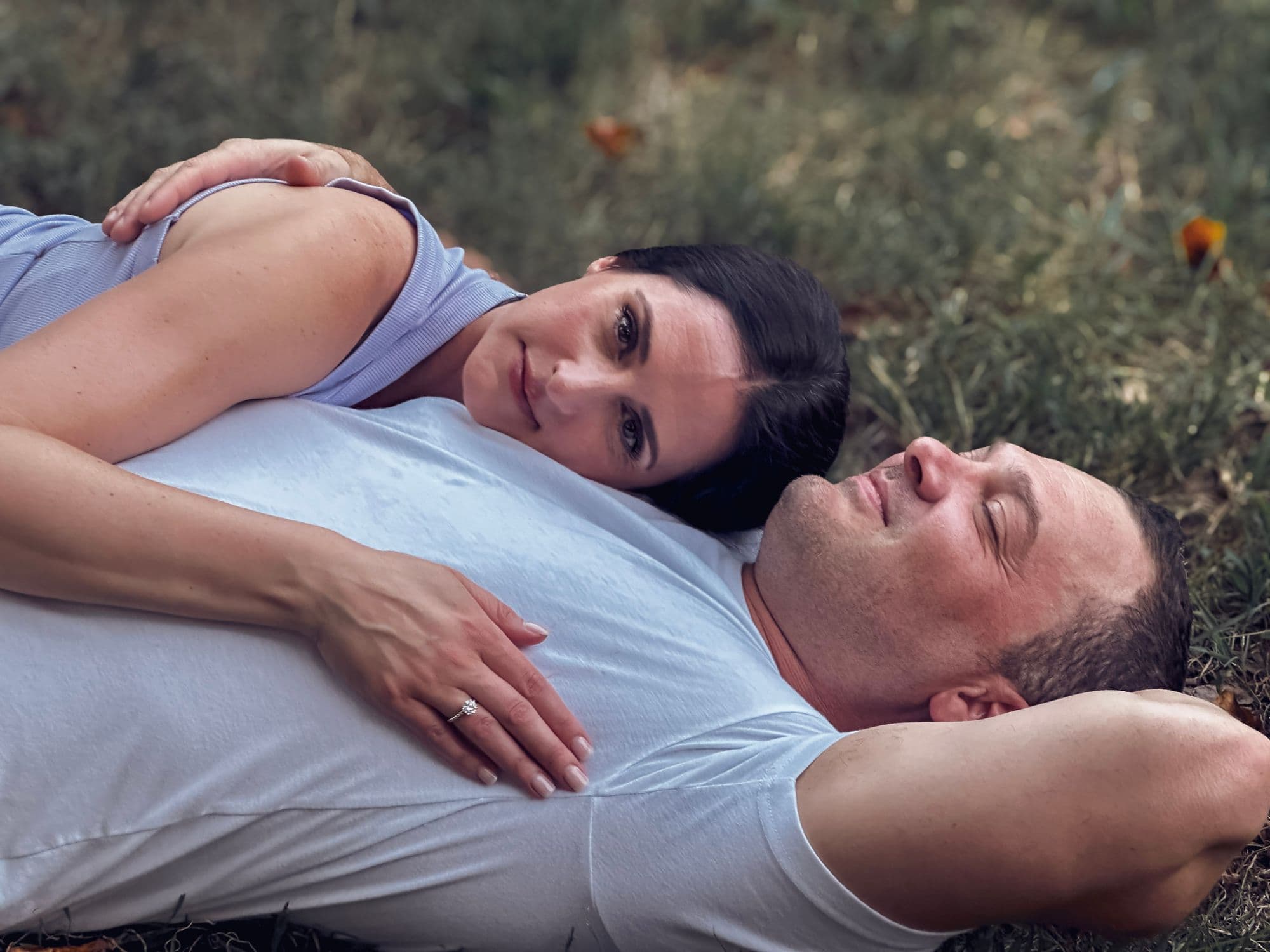 Laura and Nicholas today, recreating the same pose in the grass — ring included