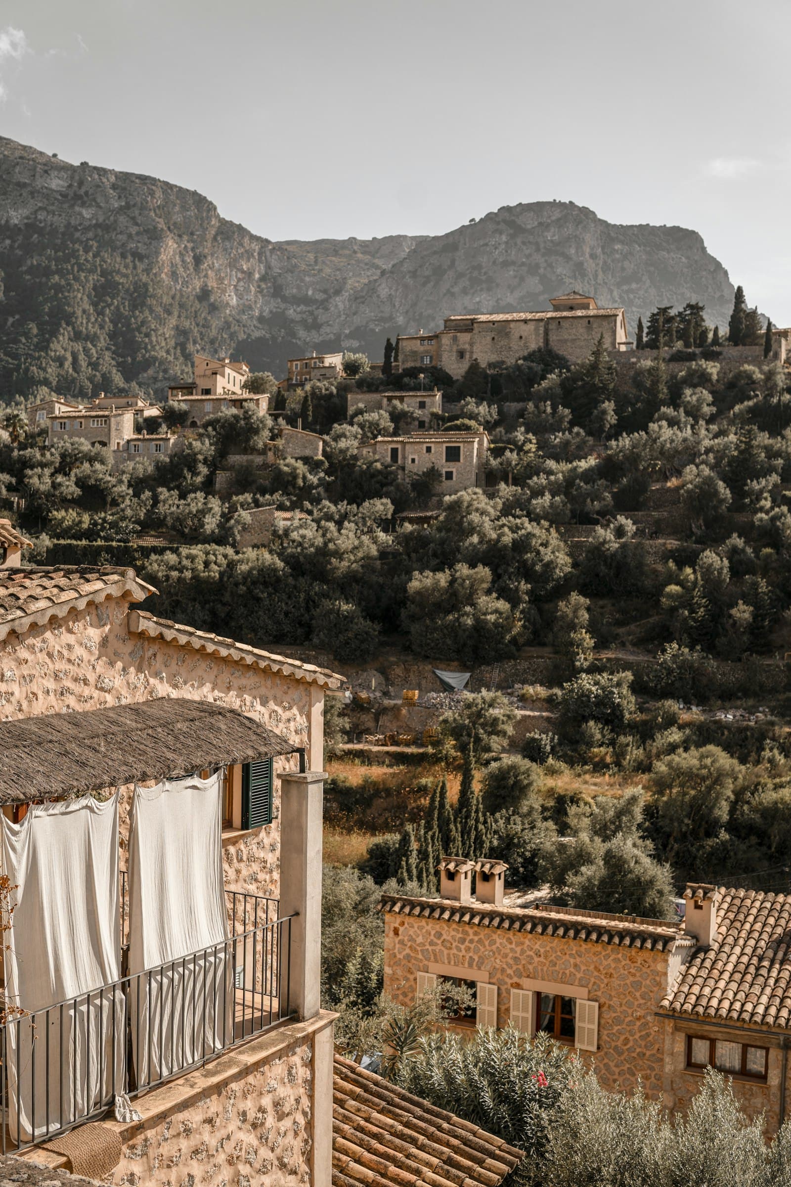 The stone houses of Deià stacked against the Tramuntana hills