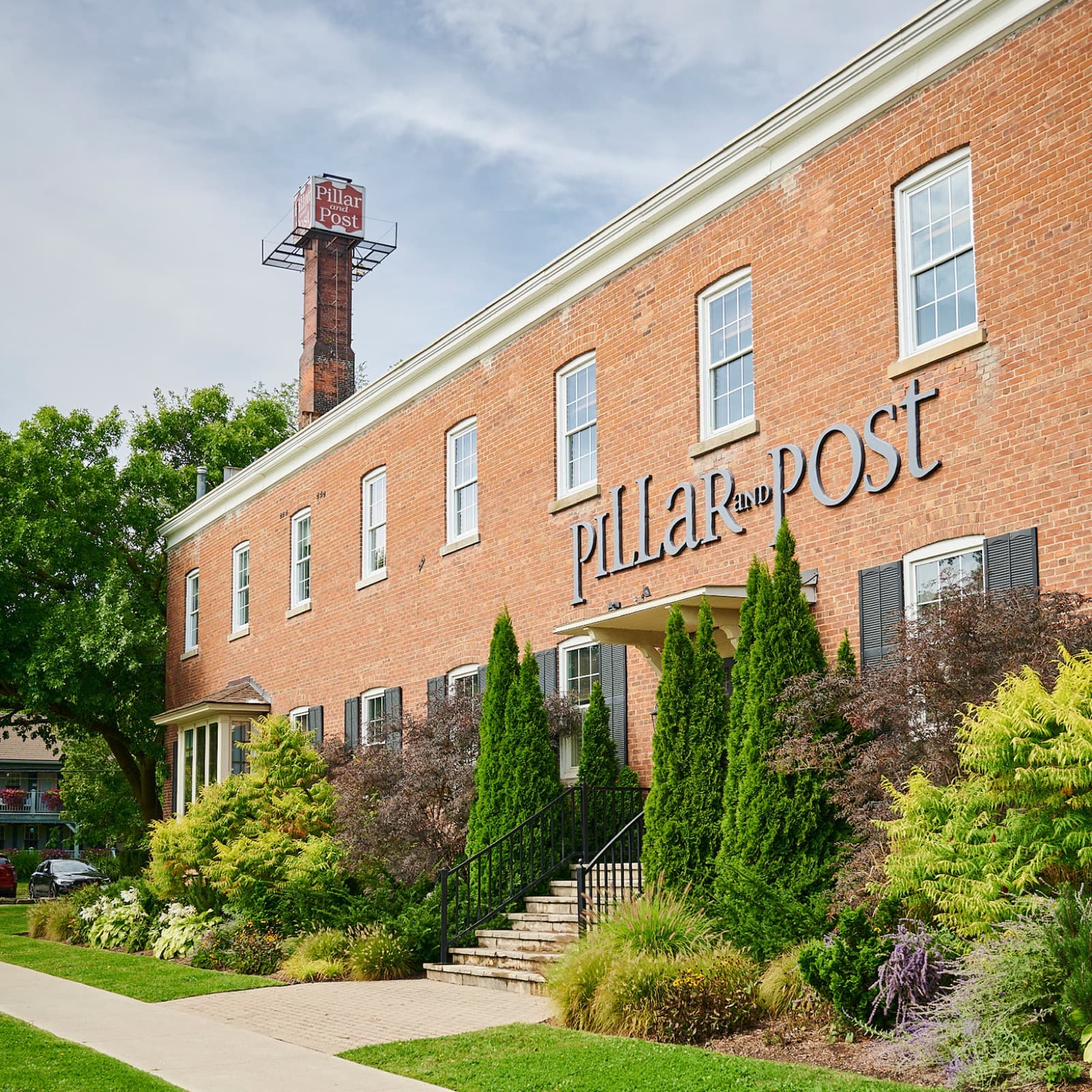 The brick facade and gardens of the Pillar and Post hotel
