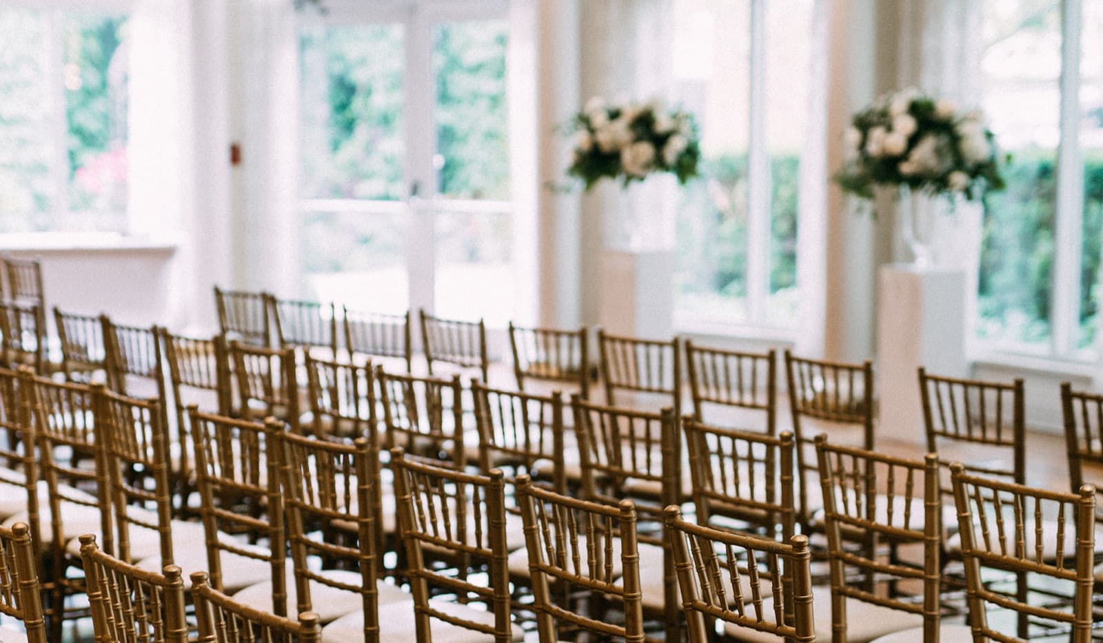 Golden chairs and florals in the light-filled venue